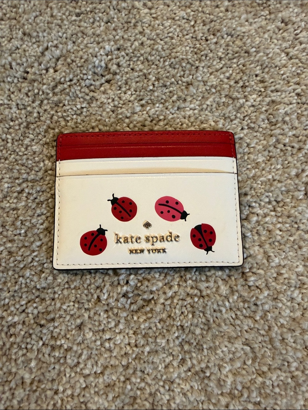 kate spade white and red ladybug cardholder
